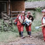 Person being carried by fire fighters